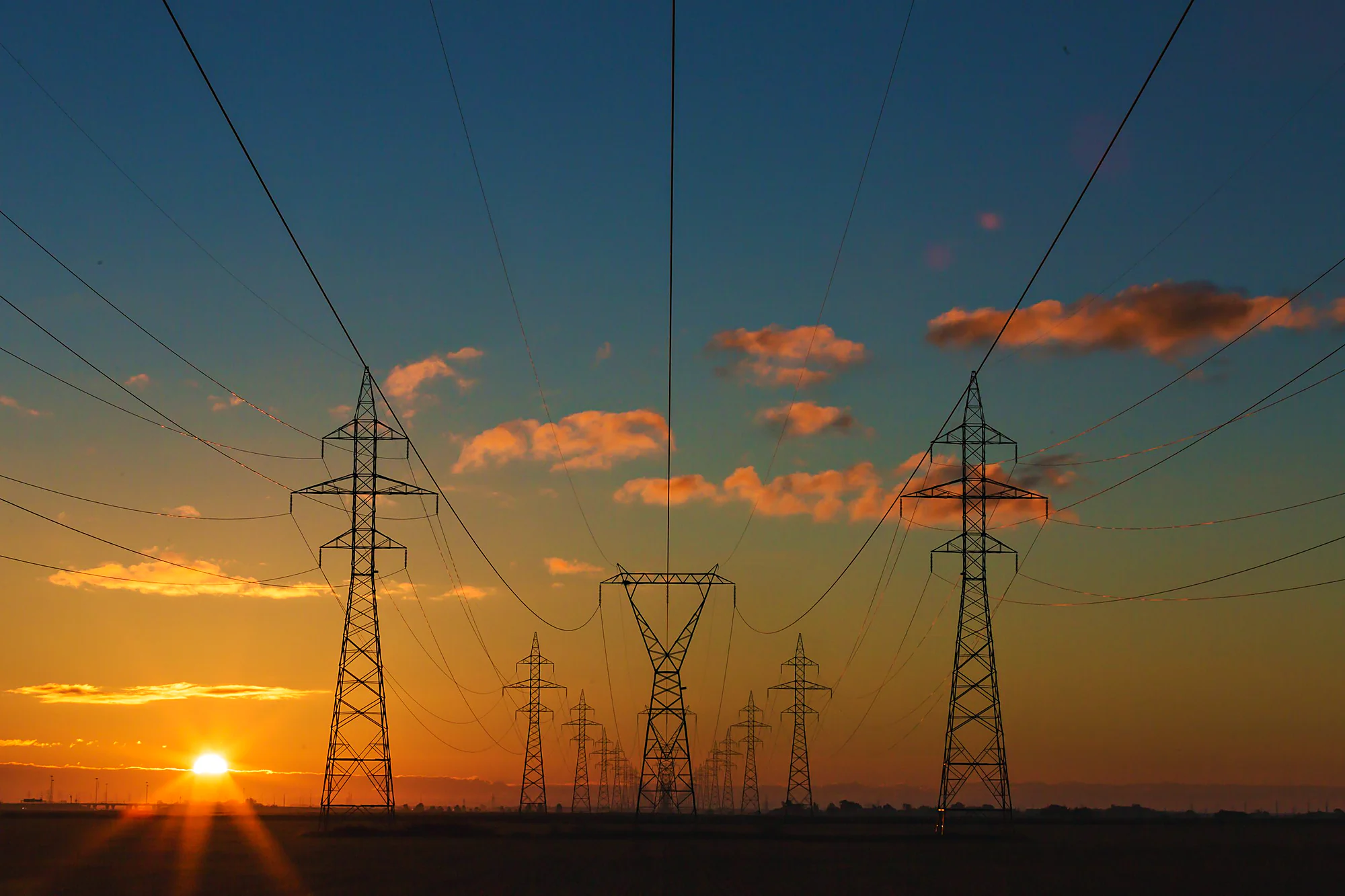 High-voltage transmission towers at dusk