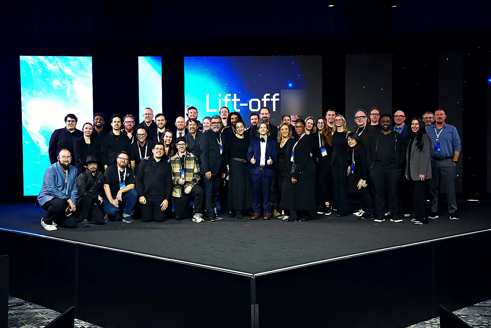 Our crew gathered on the finished general-session stage in front of the event's space-themed LED backdrop