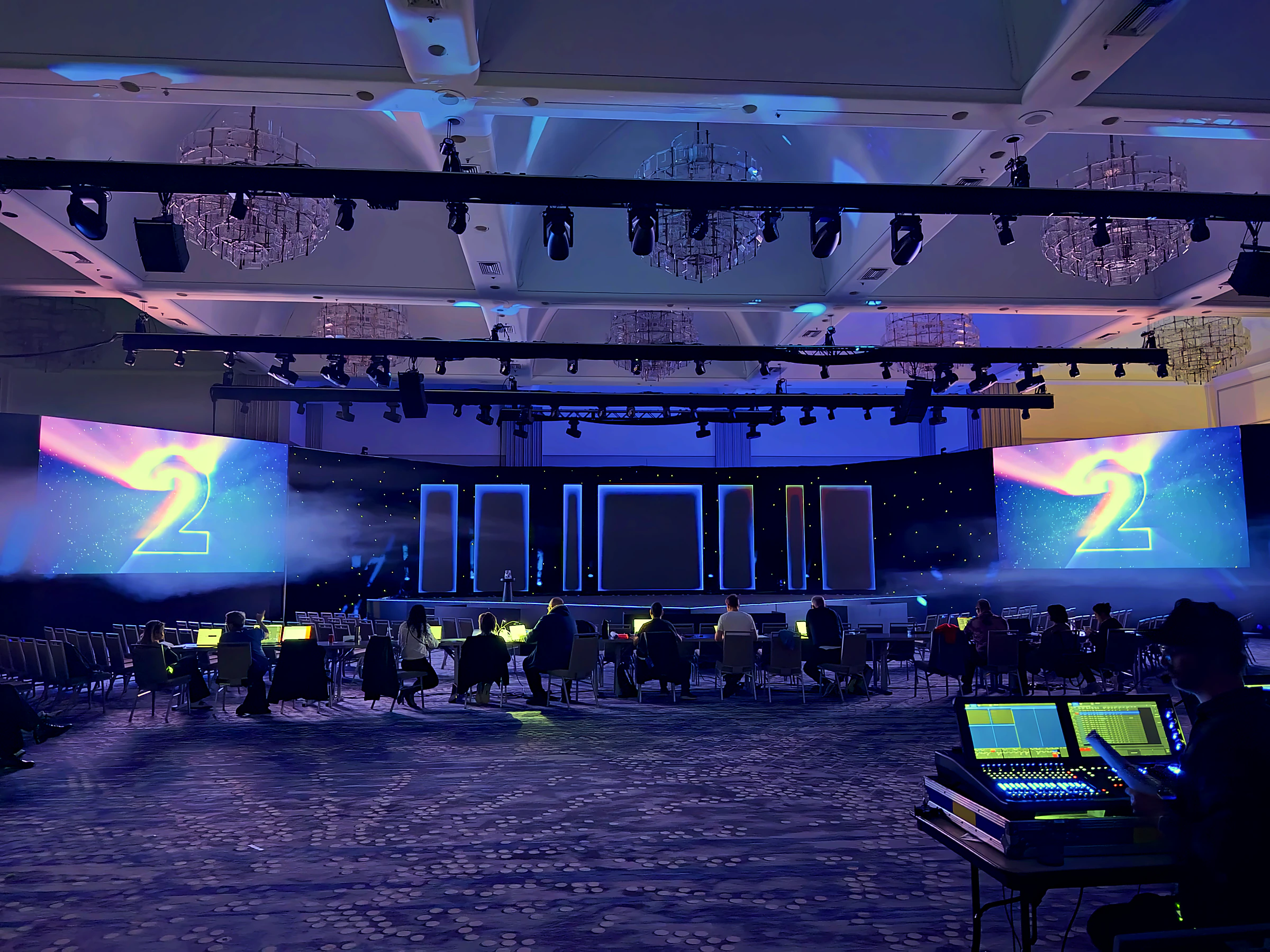 General-session keynote with a speaker on stage and slides carried across the LED wall