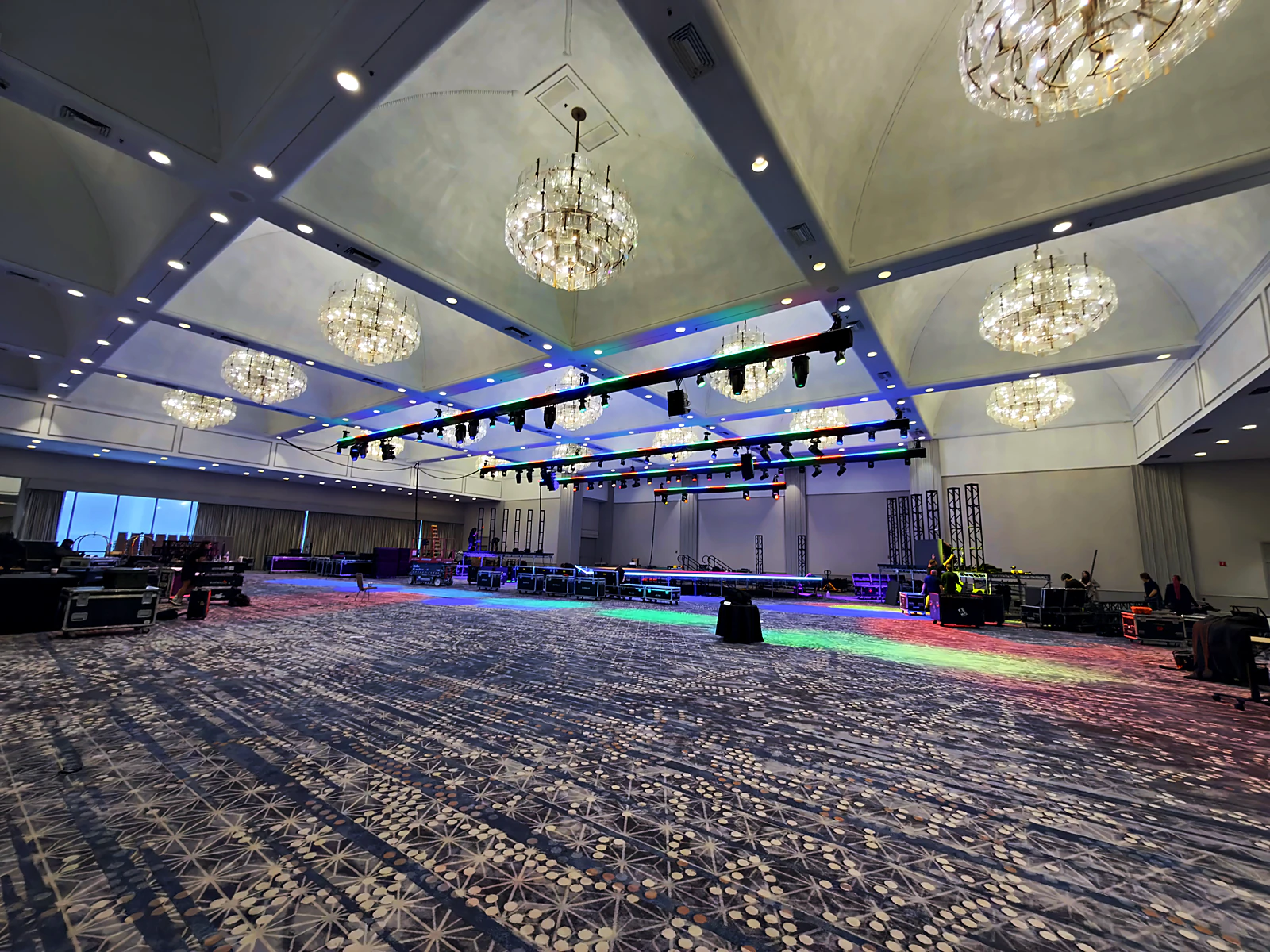 Rigging crew working a venue load-in ahead of a general-session build.