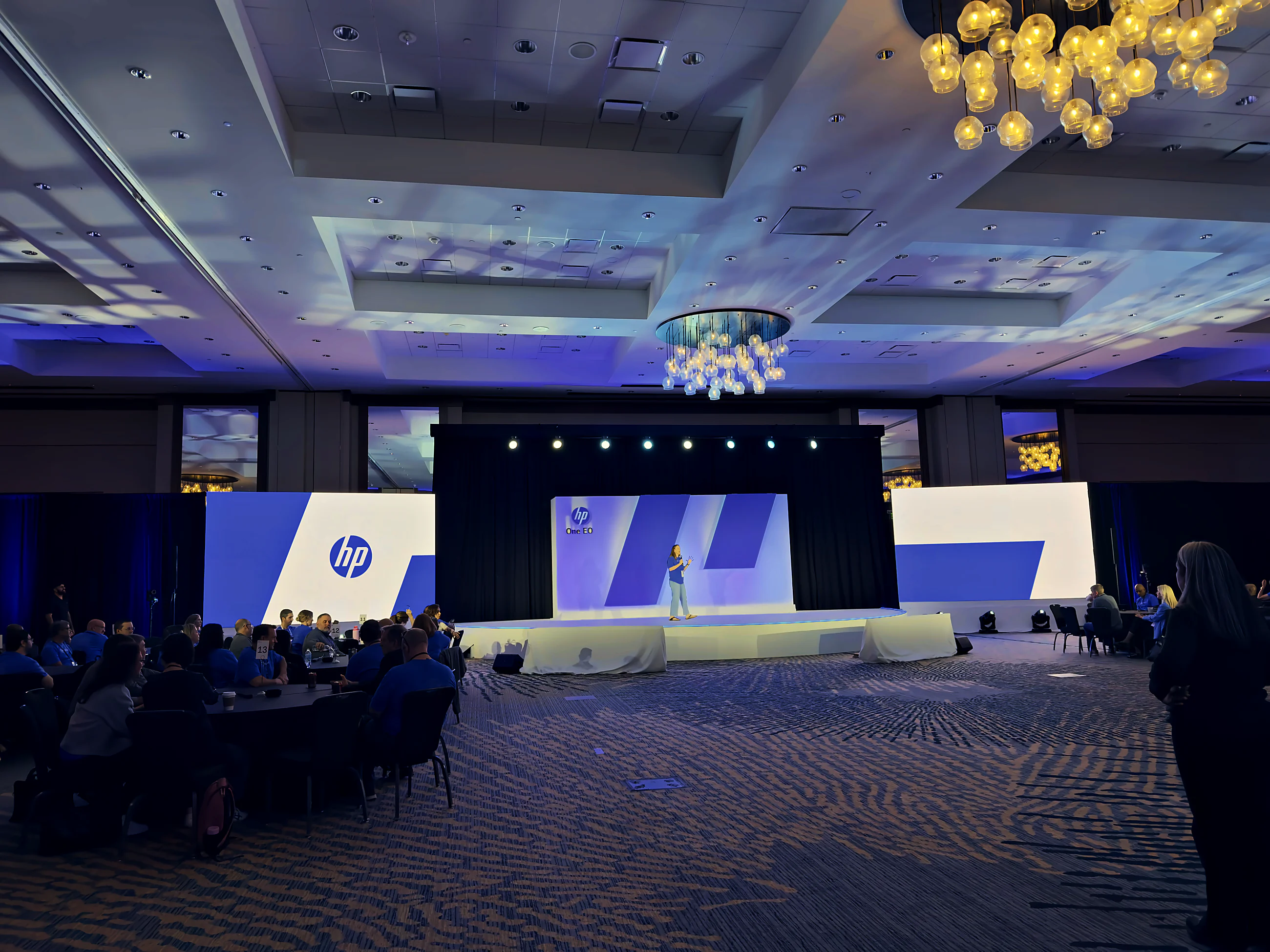 Executive summit general session on a custom half-circle white stage with LED and IMAG.