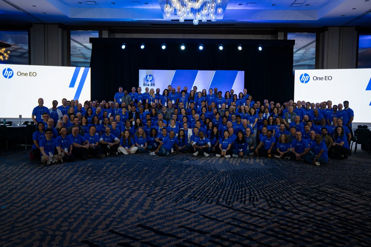 The HP One EO team gathered in front of the summit stage and screens