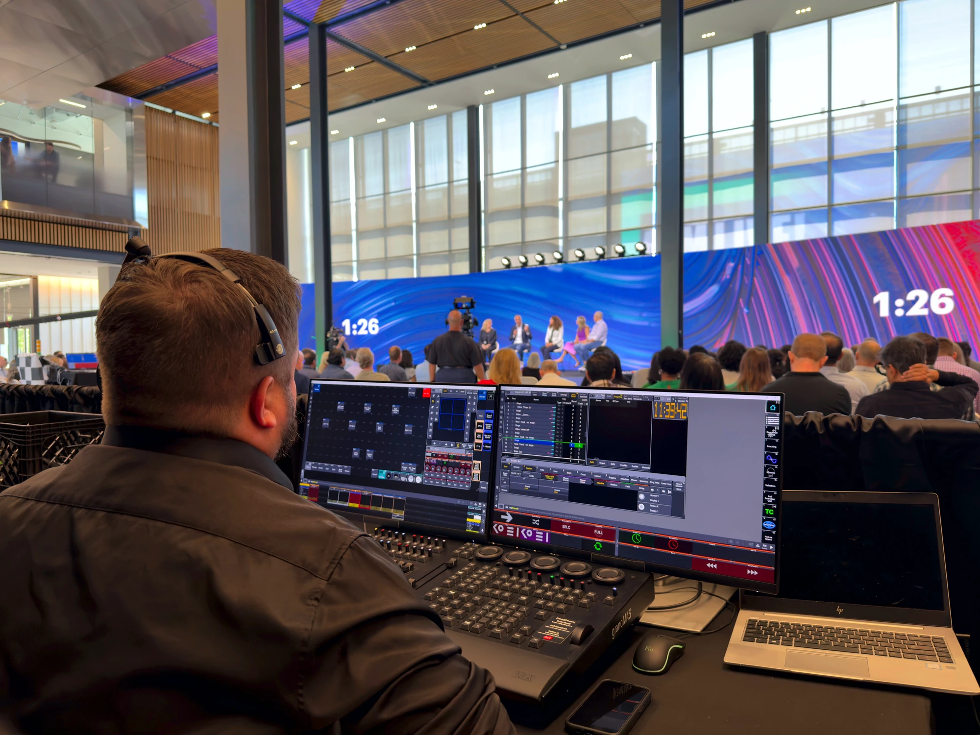 Production control village with operators during a live corporate session.