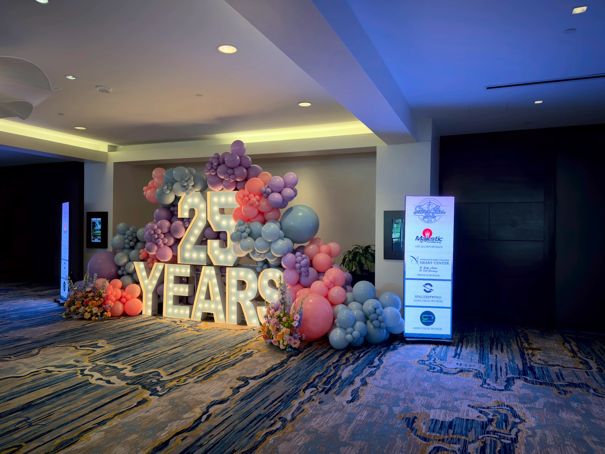 The gala sponsor wall crediting Space City Pro as audio-visual sponsor beside the 25 Years marquee